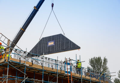 A spandrel panel being lowered into place ready to construct the NYTROOF, which is a panelised room in the roof system